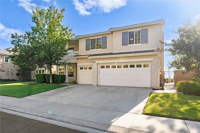 traditional home with a garage, driveway, stucco siding, fence, and a front yard