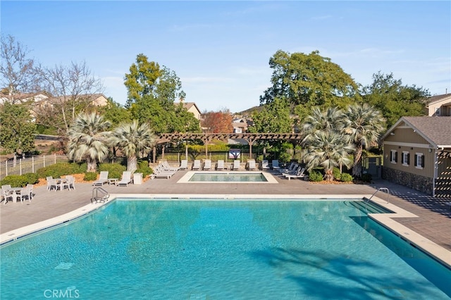 pool with fence and a patio