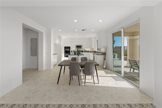 dining space with light tile patterned floors, baseboards, visible vents, and recessed lighting