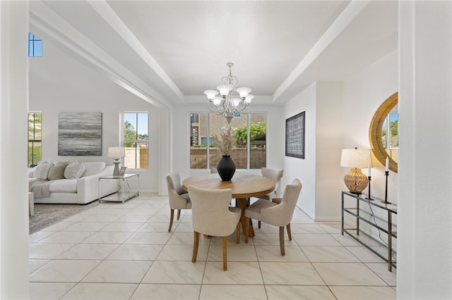 dining space featuring light tile patterned floors, baseboards, a raised ceiling, and a notable chandelier