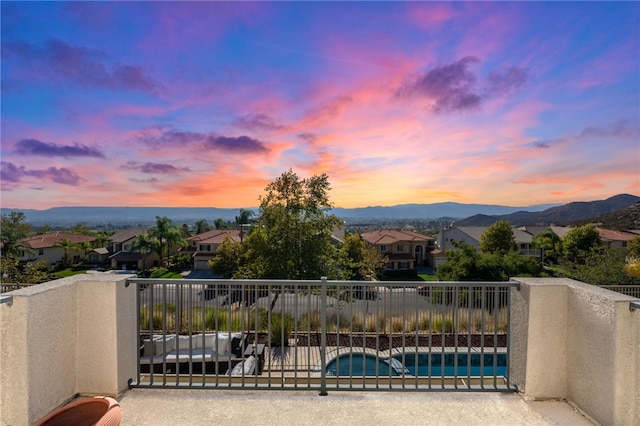 balcony at dusk with a residential view and a mountain view