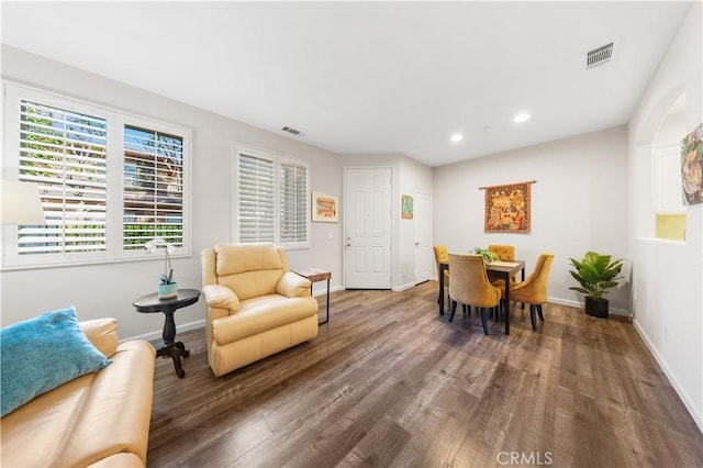 interior space with visible vents, baseboards, and wood finished floors