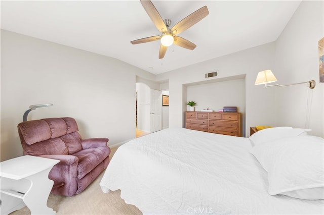 carpeted bedroom featuring visible vents and ceiling fan