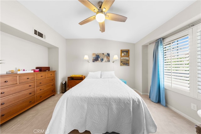 bedroom with visible vents, ceiling fan, baseboards, vaulted ceiling, and light carpet