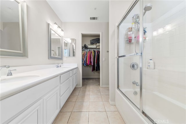 full bath featuring a sink, visible vents, combined bath / shower with glass door, and tile patterned floors