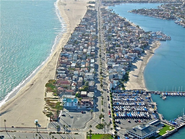 bird's eye view featuring a water view and a beach view