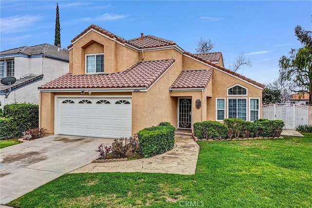 mediterranean / spanish-style home with a tile roof, stucco siding, a front yard, fence, and driveway