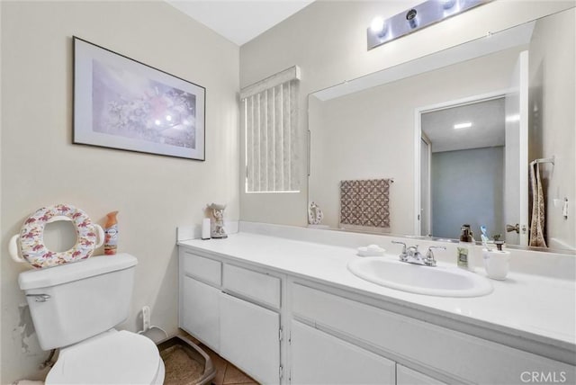 bathroom featuring toilet and vanity