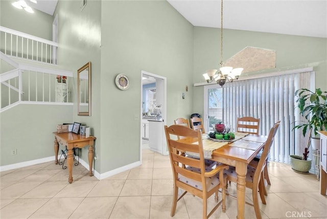 dining area with light tile patterned floors, high vaulted ceiling, a notable chandelier, visible vents, and baseboards