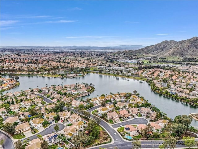 drone / aerial view featuring a water and mountain view and a residential view