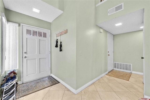 entrance foyer with light tile patterned flooring, visible vents, and baseboards