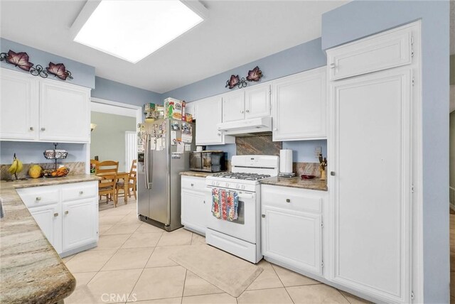 kitchen with under cabinet range hood, stainless steel fridge with ice dispenser, white cabinetry, and white gas stove