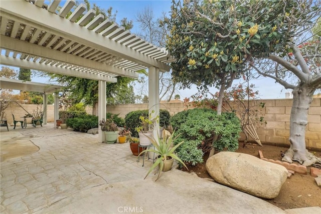 view of patio / terrace featuring a fenced backyard and a pergola