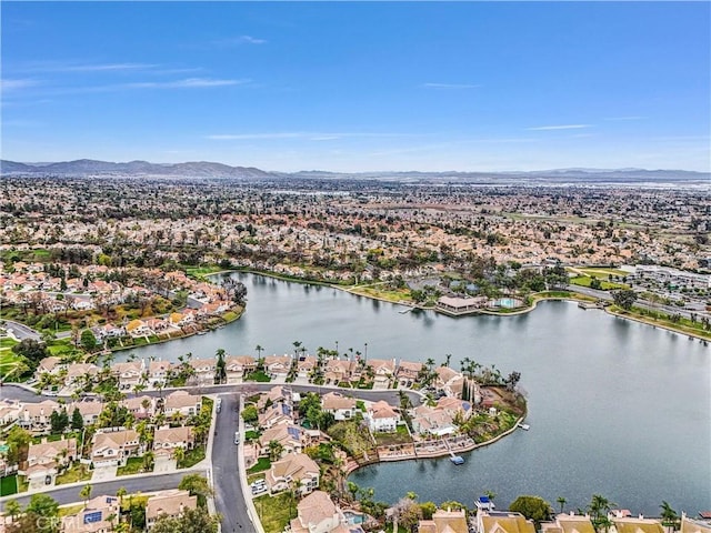 drone / aerial view featuring a water and mountain view and a residential view