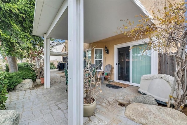 view of patio featuring fence