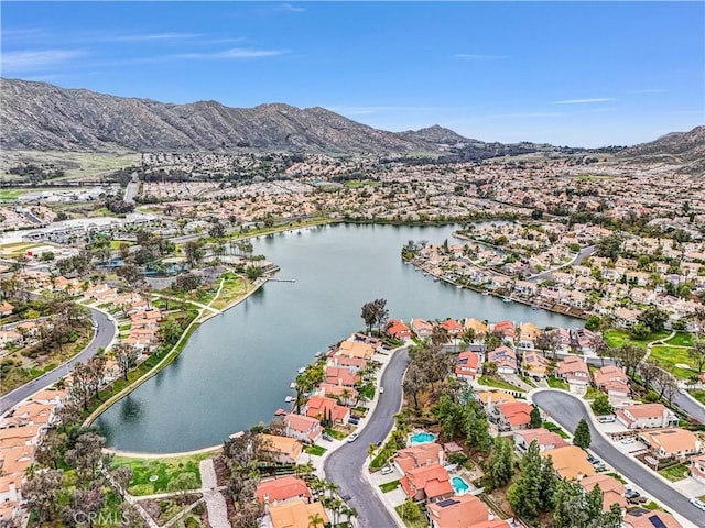 drone / aerial view featuring a residential view and a water and mountain view