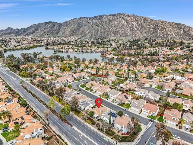 drone / aerial view with a residential view and a water and mountain view