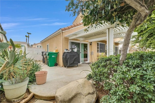 view of patio featuring fence, grilling area, and a pergola