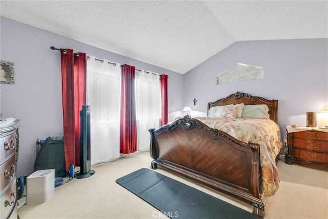 carpeted bedroom with vaulted ceiling and a textured ceiling