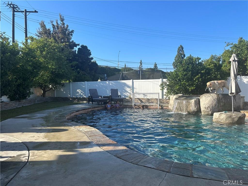 view of swimming pool featuring a patio, a fenced backyard, and a fenced in pool