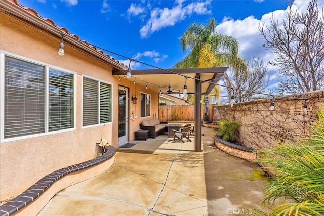 view of patio featuring a fenced backyard and ceiling fan