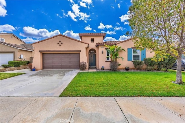 mediterranean / spanish house with driveway, a tiled roof, an attached garage, a front yard, and stucco siding