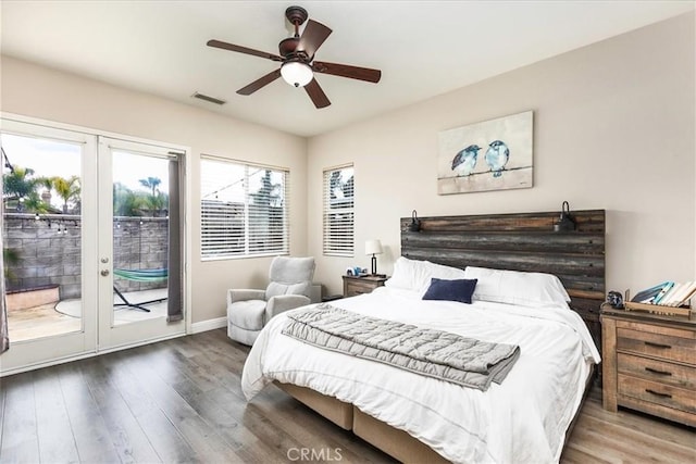 bedroom featuring baseboards, visible vents, a ceiling fan, wood finished floors, and access to outside