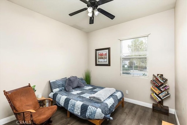 bedroom with ceiling fan, baseboards, and wood finished floors