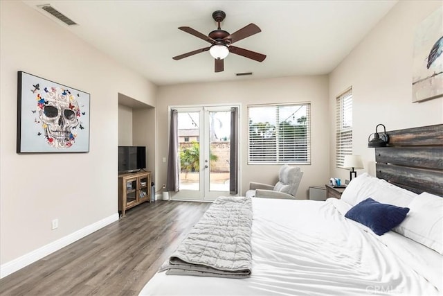 bedroom featuring access to exterior, baseboards, visible vents, and wood finished floors