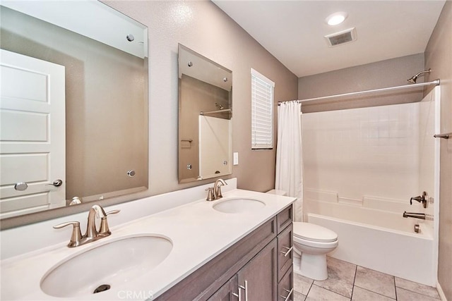 bathroom with toilet, visible vents, a sink, and shower / tub combo with curtain