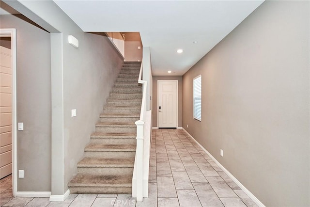 staircase featuring recessed lighting, tile patterned floors, and baseboards