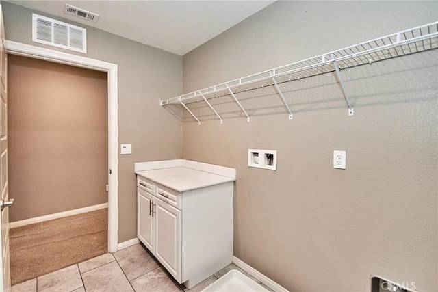 laundry room featuring washer hookup, cabinet space, visible vents, and baseboards