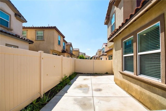 view of patio / terrace featuring a fenced backyard and a residential view