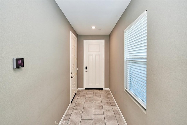 entryway featuring light tile patterned floors and baseboards