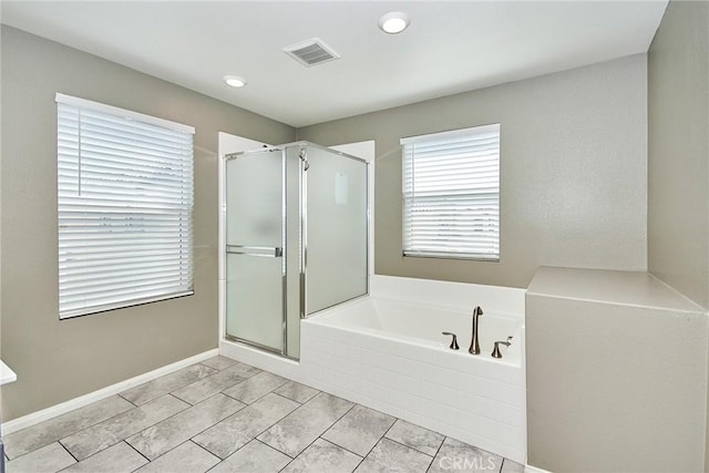 bathroom with a stall shower, baseboards, visible vents, and a bath