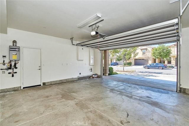 garage with a garage door opener, water heater, and baseboards