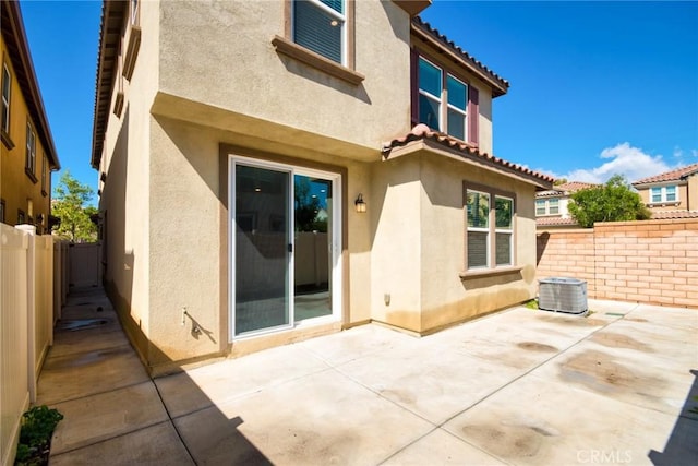 rear view of property with a patio area and stucco siding