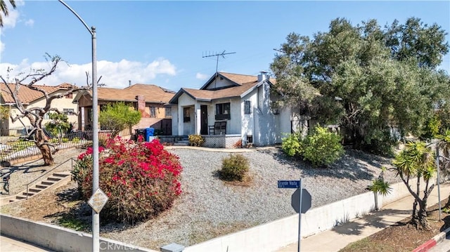 bungalow featuring fence