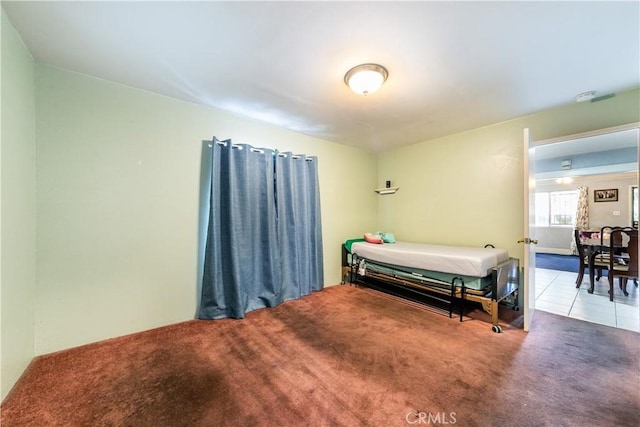 bedroom with carpet floors and tile patterned floors