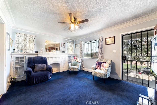 sitting room featuring carpet floors, a fireplace, crown molding, ceiling fan, and a textured ceiling