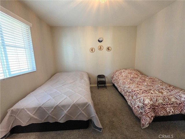 bedroom with carpet and baseboards