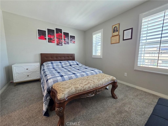 carpeted bedroom featuring baseboards