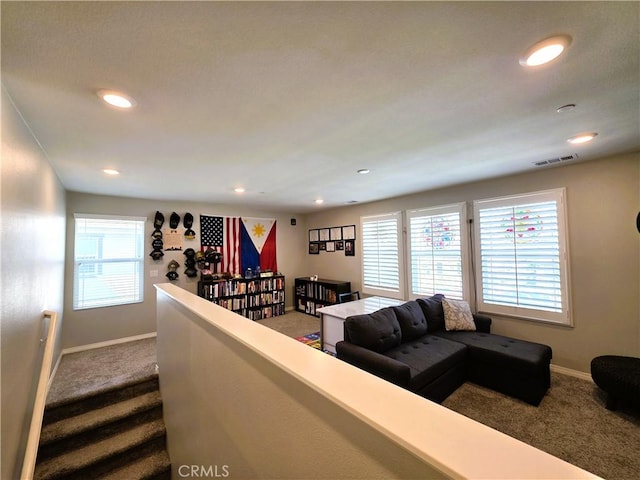 carpeted living room featuring recessed lighting, visible vents, and baseboards