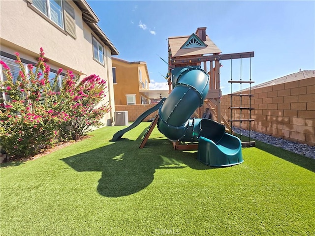 view of jungle gym with a yard and fence