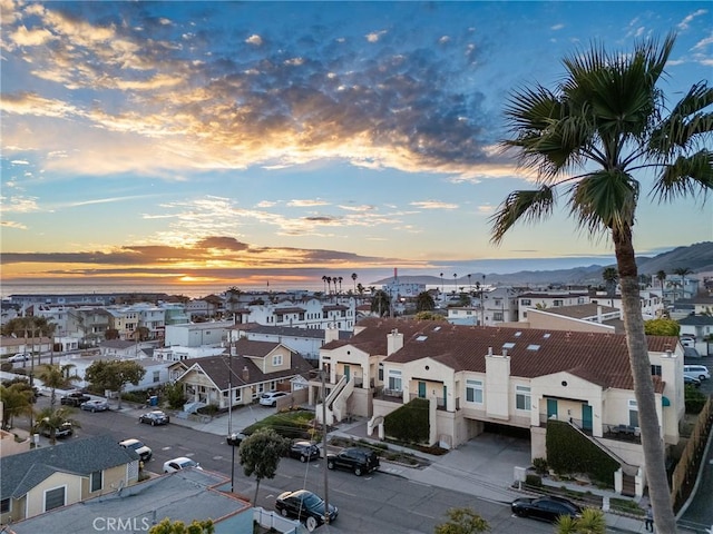 aerial view at dusk featuring a residential view