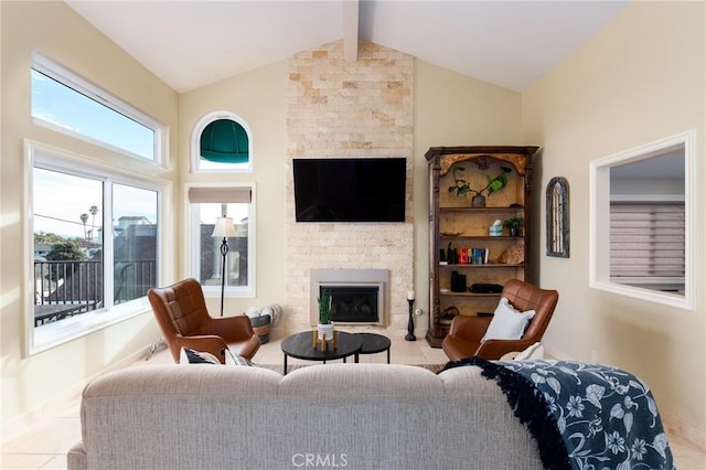 living area with lofted ceiling with beams and a large fireplace