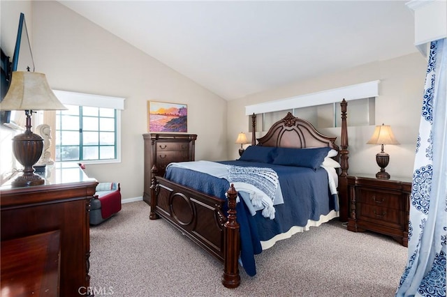 carpeted bedroom with lofted ceiling and baseboards