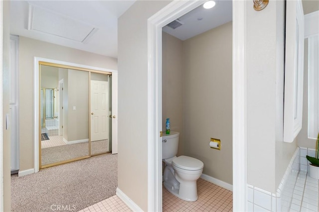 bathroom featuring baseboards, visible vents, toilet, and tile patterned floors