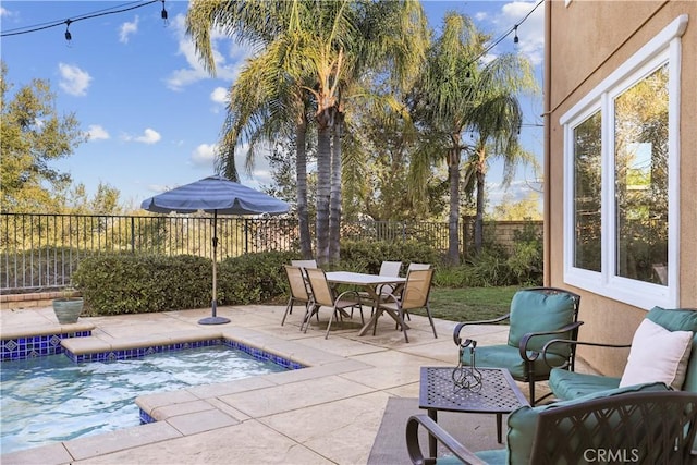 view of swimming pool featuring a patio, a fenced backyard, and outdoor dining space