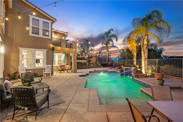 view of pool with a fenced in pool, a playground, a fenced backyard, and a patio area